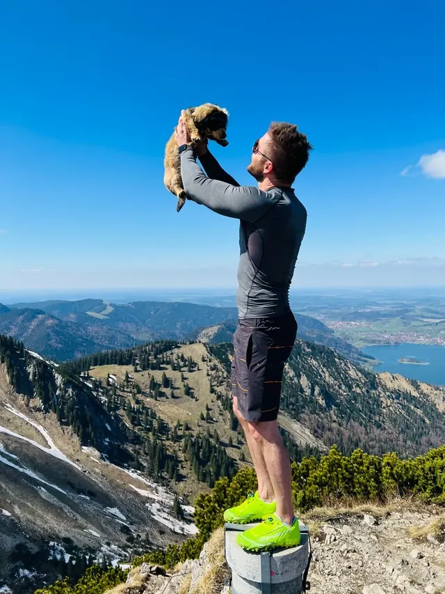 Sebastian lifting Rosi on a mountain summit